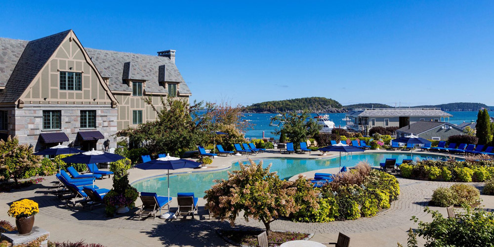 Aerial view of a waterfront hotel and pool
